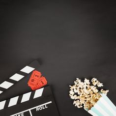 popcorn and movie claps on a black background