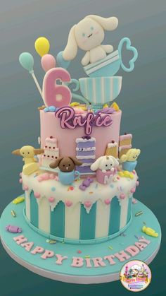 a blue and pink birthday cake with an elephant on top