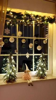 a window with christmas decorations on the windowsill