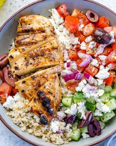 a bowl filled with chicken, rice and vegetables