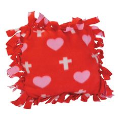 a red and white pillow with hearts on it