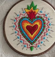 an embroidered heart on a white background