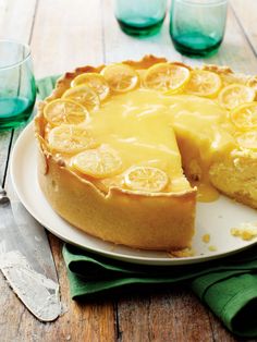 a lemon pie on a plate with one slice missing