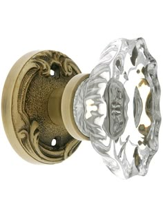 an antique style door handle with glass knobs