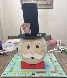 a monopoly board game with a man's hat on top