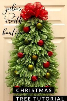 a christmas tree made out of green leaves and red bows with the words julia's wreath bouting on it