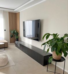 a large flat screen tv mounted to the side of a wall in a living room