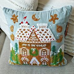 a decorative pillow with a gingerbread house on it