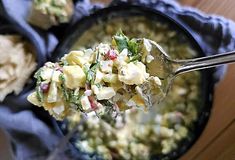 a spoon full of food on top of a table