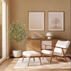 a living room with two framed pictures and a plant in the corner next to a chair