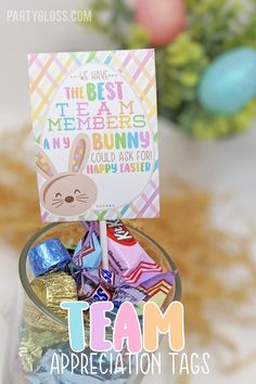 a glass jar filled with chocolate candies and an easter card on top of it