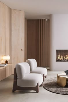 a living room with two white chairs and a fire place in the middle of it