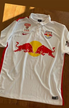 a white shirt with red bulls on it