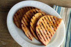 three pieces of grilled chicken on a white plate