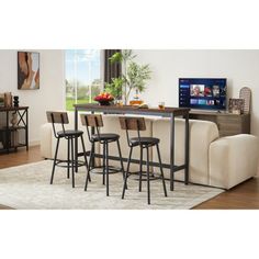 a living room filled with furniture and a flat screen tv on top of a wooden table