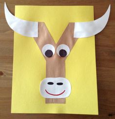 the paper cow is cut out to look like it has horns and eyes on it