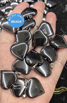 a person is holding some black and silver guitar picks in their hand with the words diy sale beads on it