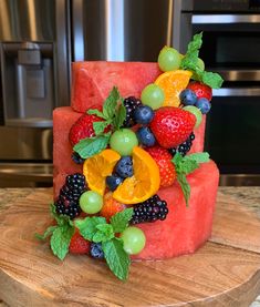 a watermelon cake decorated with fresh fruit