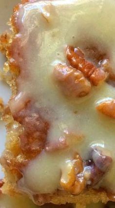 a close up of a piece of food on a plate with cheese and toppings