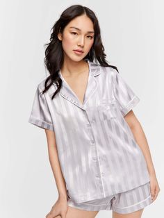 Make it a luxe night in with our silver satin PJ shirt. Featuring an all over soft self-stripe effect and contrast white trims, this shirt adds a perfect touch to your sleepwear wardrobe. Make sure to pair it with the matching PJ shorts for the perfect bedtime look! * Smooth self stripe satin in matte and silky finish effect featuring Penny logo * Added elastane for a little stretch * Collar & button down front * Top pocket with embroidered Penny logo * Short sleeves Model is usually a size 8 and wears a small. Silver Penny, Satin Sleepwear, Maternity Coat, Satin Short, Maternity Skirt