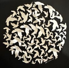 a circle made out of white birds on a black background