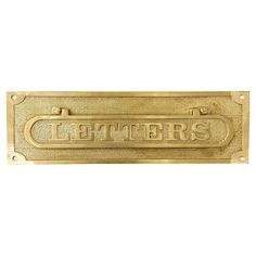 a brass sign that says letters on it