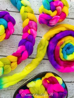 the colorful yarn is being used to make rainbow lollipops