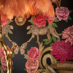 the wallpaper is decorated with pink flowers and leopards, gold accents and a golden lamp