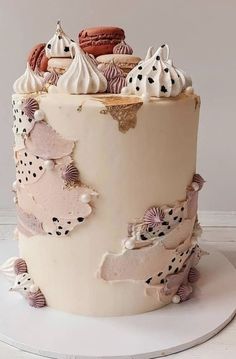 there is a cake decorated with seashells and other things on the top layer