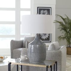 a table with a lamp on it in a living room