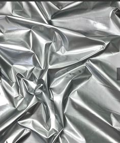 an up close shot of shiny silver fabric that looks like it could be used as a background