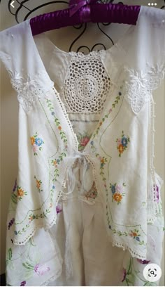 a white blouse with flowers and lace on it