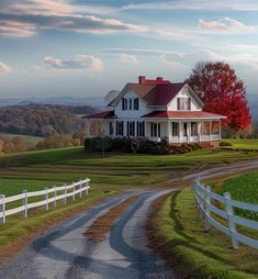 a large white house sitting on top of a lush green field next to a road