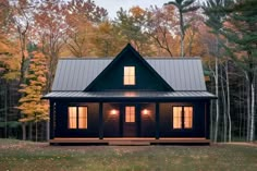 a small cabin in the woods at night with lights on it's front windows