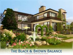 the black and brown house is surrounded by flowers