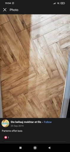 an image of a wooden floor being cleaned by someone using the app on their phone