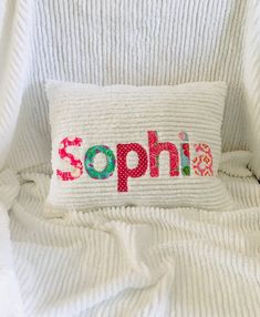 a white pillow with the word sophi on it