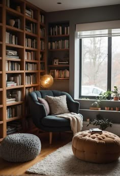 a living room filled with furniture and bookshelves next to a large window covered in lots of books