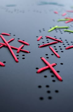 some red and green crosses on a black surface