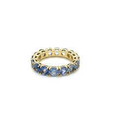 a yellow gold ring with blue sapphire stones