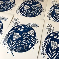 six blue and white paper cut designs on top of each other with leaves in the middle