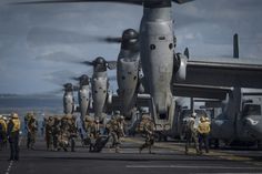 Marines from the 11th Marine Expeditionary Unit (11th MEU) board MV-22 Ospreys attached to Marine Medium Tiltrotor Squadron 163 (Reinforced) as they prepare to launch from the flight deck of the amphibious assault ship USS Makin Island (LHD-8) on Feb. 23, 2015. US Navy Photo Photo Avion, Us Marines, United States Marine Corps, Flight Deck, Military Men, Aircraft Carrier