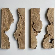 three pieces of wood sitting on top of a white surface