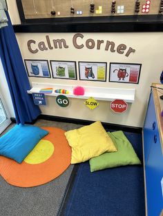 a room with various pillows and pictures on the wall