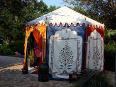 an outdoor tent with curtains on the outside