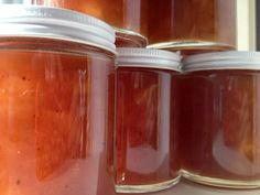 several jars filled with different kinds of food