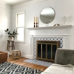 a living room with white walls and fireplace