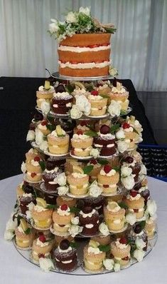 a large tower of cupcakes on top of a table