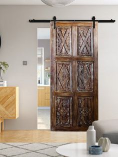 a living room filled with furniture and a wooden door