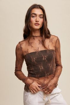 Give any outfit an instant upgrade with this statement layering top! Our Made For You Mesh Lace Layering Top in Mocha features a stretchy, lightweight, sheer mesh fabric with lace embroidery, long sleeves, and a mock neck. Also available in black and cream! Fabric is sheer and unlined. Does not include tank, bodysuit or undershirt included in photos. Model is wearing a size small. Mock Neck Layering, Lace Layering Top, Layered Lace Top, Long Sleeve Layering, Mesh Embroidery, Flannel Tops, Lace Top Long Sleeve, Layered Tops, Basic Long Sleeve